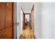 Bright hallway featuring wood-look flooring and access to other rooms in the house at 134 N 6Th Ave, Brighton, CO 80601