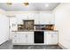 Well-lit kitchen featuring white cabinets, modern appliances, dark backsplash and stylish countertop at 134 N 6Th Ave, Brighton, CO 80601