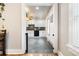 Kitchen view from the dining room showing white cabinets and black appliances at 134 N 6Th Ave, Brighton, CO 80601