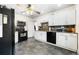 Updated kitchen with black appliances, granite countertops, and white cabinetry at 134 N 6Th Ave, Brighton, CO 80601