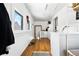 Bright laundry room featuring a washer, dryer, windows and a door to the outside at 134 N 6Th Ave, Brighton, CO 80601