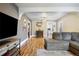 Inviting living room with hardwood floors, large sectional sofa, and open dining area at 134 N 6Th Ave, Brighton, CO 80601