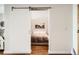 Bedroom sliding door with view into bedroom showing modern minimalist decor at 3100 Huron St # 3E, Denver, CO 80202
