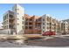 Modern multi-story building with balconies and street parking at 3100 Huron St # 3E, Denver, CO 80202