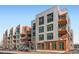 Modern condo building showcasing sleek design, balconies, and city views on a sunny day at 3100 Huron St # 3E, Denver, CO 80202