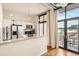 Contemporary kitchen with sleek white cabinetry, stainless steel appliances, and views from the balcony at 3100 Huron St # 3E, Denver, CO 80202