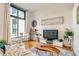 Modern living room with an open concept, hardwood flooring, great natural light and contemporary decor at 3100 Huron St # 3E, Denver, CO 80202
