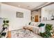 Comfortable living room setup with modern decor, hardwood floors, and a view into the kitchen area at 3100 Huron St # 3E, Denver, CO 80202