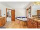 Spacious bathroom with double vanities, a soaking tub, and an open doorway with a view of the fireplace at 29477 Blue Moon Dr, Evergreen, CO 80439