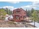 Beautiful two-story log home with multiple decks, perfect for outdoor living and enjoying the surrounding mountain views at 29477 Blue Moon Dr, Evergreen, CO 80439