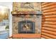 Stone fireplace with decorative metal mountain and bear sculpture in the living room at 29477 Blue Moon Dr, Evergreen, CO 80439