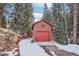 Single-car log garage with a decorative star that offers secure parking and storage space at 29477 Blue Moon Dr, Evergreen, CO 80439