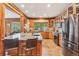 Spacious kitchen featuring an island, breakfast bar, granite counters, and custom cabinetry at 29477 Blue Moon Dr, Evergreen, CO 80439