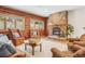 Cozy living room featuring log walls, a stone fireplace, and comfortable seating at 29477 Blue Moon Dr, Evergreen, CO 80439