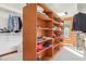 Large walk-in closet with custom built-in shelving and a window with abundant natural light at 29477 Blue Moon Dr, Evergreen, CO 80439