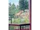 A majestic elk grazes on the hillside, seen from the porch, highlighting the natural beauty of the property at 29477 Blue Moon Dr, Evergreen, CO 80439