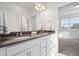 Bathroom with double sink vanity, countertop, and modern fixtures and an entrance to another room at 10295 E 59Th Ave, Denver, CO 80238
