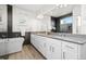 Luxurious bathroom featuring a freestanding tub, a glass enclosed shower, and double vanity sinks with modern fixtures at 10295 E 59Th Ave, Denver, CO 80238