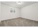 Bedroom with neutral carpeting and a window with white shutters at 10295 E 59Th Ave, Denver, CO 80238