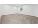Bedroom featuring neutral carpeting and a window with white shutters at 10295 E 59Th Ave, Denver, CO 80238