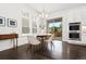 Bright dining area with hardwood floors, modern light fixture, and backyard view at 10295 E 59Th Ave, Denver, CO 80238