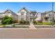 Charming two-story home featuring stone accents, a front porch, and solar panels at 10295 E 59Th Ave, Denver, CO 80238
