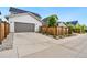 Exterior view of home featuring a two-car garage and fenced in backyard at 10295 E 59Th Ave, Denver, CO 80238