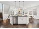 Spacious kitchen island with stainless steel appliances and hardwood floors at 10295 E 59Th Ave, Denver, CO 80238