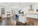 Open-concept kitchen with white cabinets, stainless steel appliances, and bar seating at 10295 E 59Th Ave, Denver, CO 80238