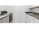 Laundry room with modern washer and dryer and white cabinets at 10295 E 59Th Ave, Denver, CO 80238