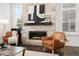 Cozy living room with modern fireplace, leather chairs, and designer accents at 10295 E 59Th Ave, Denver, CO 80238