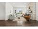 Bright living room showcasing hardwood floors, a stylish fireplace, and comfortable seating at 10295 E 59Th Ave, Denver, CO 80238