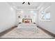 Bright main bedroom featuring a plush bed, modern decor, and ample natural light from two large windows at 10295 E 59Th Ave, Denver, CO 80238