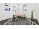 Bright home office space featuring modern desk, stylish rug, and natural light from large windows at 10295 E 59Th Ave, Denver, CO 80238