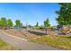 Neighborhood playground featuring a climbing structure with slides, multiple swings and seating at 10295 E 59Th Ave, Denver, CO 80238