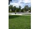 Outdoor basketball court in a park setting with lush green grass and mature trees at 2521 Billings St, Aurora, CO 80011