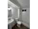 Basement bathroom with white subway tile shower and classic pedestal sink at 2521 Billings St, Aurora, CO 80011