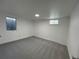 Basement bedroom with neutral carpet and egress window at 2521 Billings St, Aurora, CO 80011