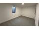 Basement bedroom with neutral carpet and egress window at 2521 Billings St, Aurora, CO 80011