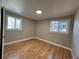 Empty bedroom showcases hardwood floors and two large windows that provide ample natural light at 2521 Billings St, Aurora, CO 80011