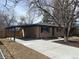 Charming brick home with a covered carport and a freshly poured concrete driveway at 2521 Billings St, Aurora, CO 80011