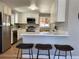 Bright kitchen with stainless steel appliances, white cabinets and breakfast bar seating at 2521 Billings St, Aurora, CO 80011