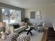 Comfortable living room featuring a neutral color palette and ample natural light from a large window at 2521 Billings St, Aurora, CO 80011