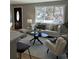 Comfortable living room featuring a neutral color palette and ample natural light from a large window at 2521 Billings St, Aurora, CO 80011