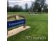 View of the manicured lawn and benches at Cottonwood Park on a sunny day at 2521 Billings St, Aurora, CO 80011