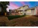 The exterior of the home includes a large backyard area with synthetic turf and mature trees at 12671 E Bates Cir, Aurora, CO 80014