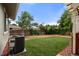 Spacious backyard featuring well-maintained synthetic turf, a fence, and mature trees at 12671 E Bates Cir, Aurora, CO 80014