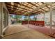 Backyard patio with covered seating, wood benches, and concrete patio at 12671 E Bates Cir, Aurora, CO 80014
