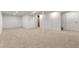 Spacious finished basement with neutral carpeting and access to storage and utility areas at 12671 E Bates Cir, Aurora, CO 80014