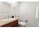 Cozy powder room with a stylish vanity, mirror, and neutral color palette at 12671 E Bates Cir, Aurora, CO 80014